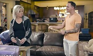 Blonde-haired mature pleases tattooed ladies' on leather couch